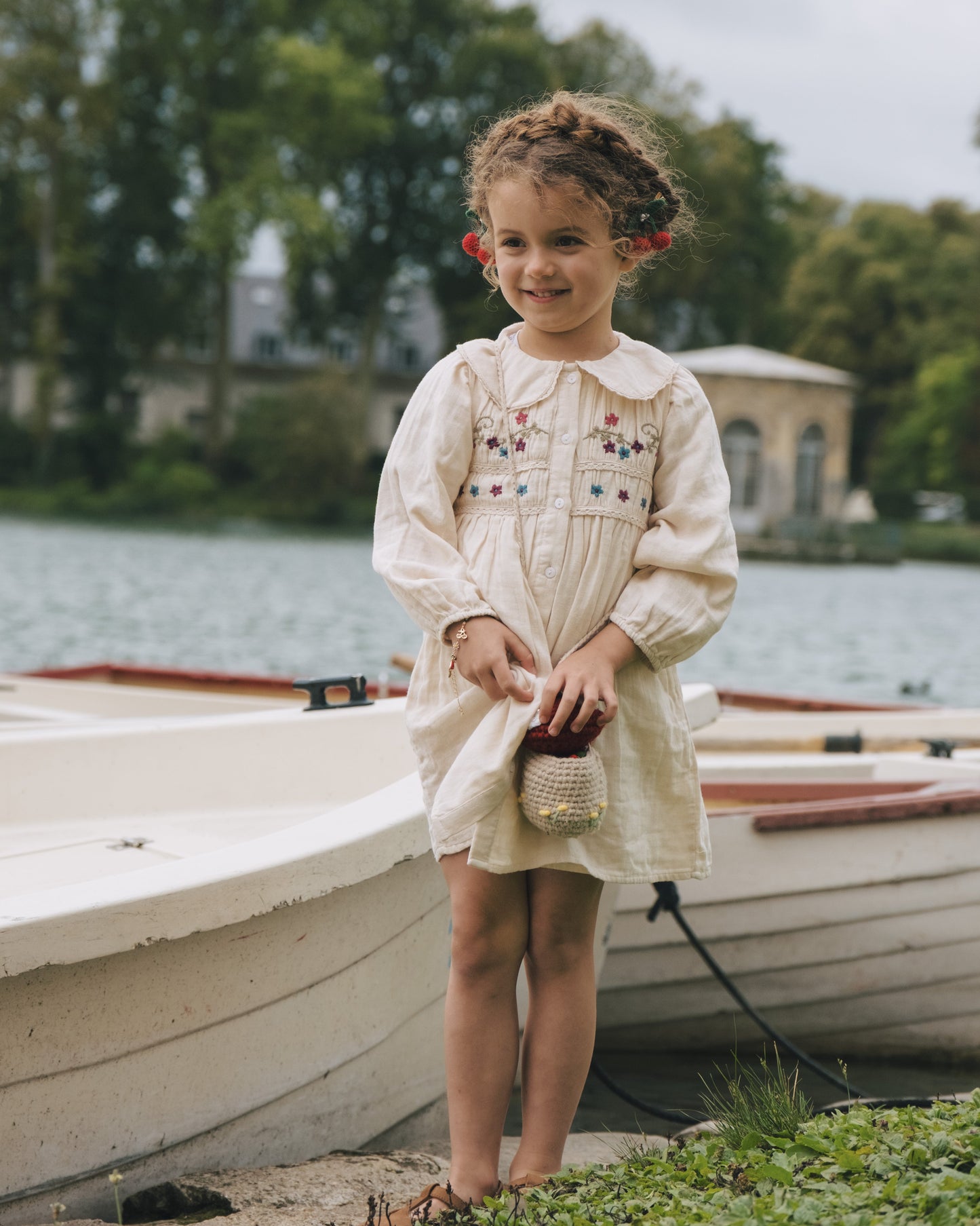 Little girl wearing hand-crocheted cherry clips in a ponytail